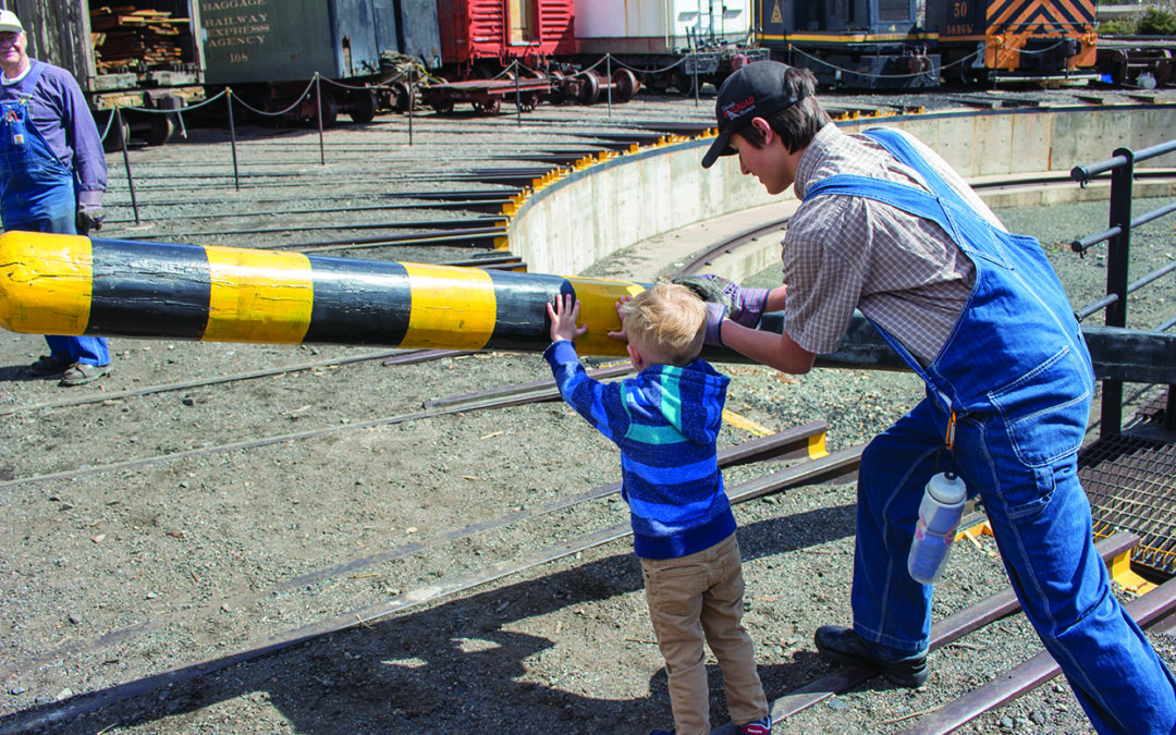 Child Pushes Turntable with Volunteer